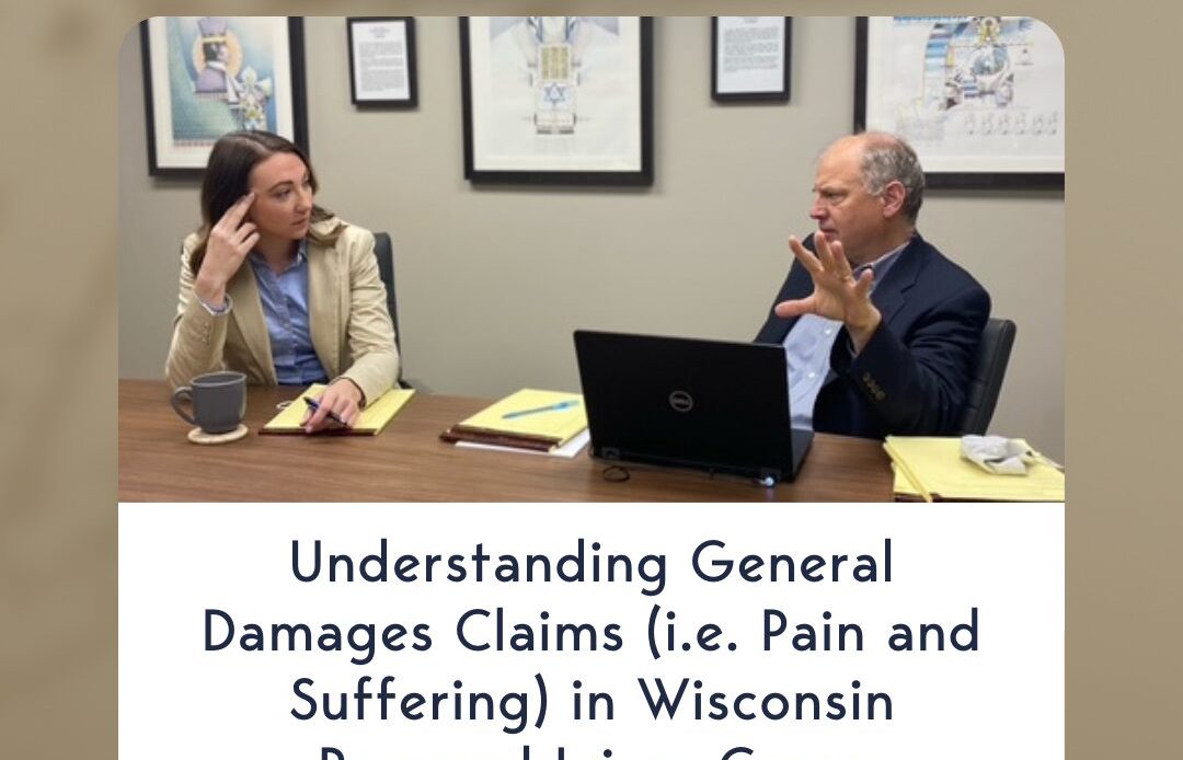Two legal professionals engaged in discussion at a conference table, symbolizing the importance of understanding general damages in Wisconsin personal injury cases.